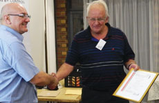 Eric Carter (right) presents Mike O’Neill his certificate after the presentation.